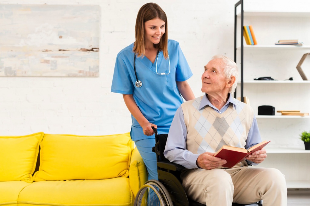 old-man-sitting-on-wheelchair-while-talking-to-nurse (1).jpg